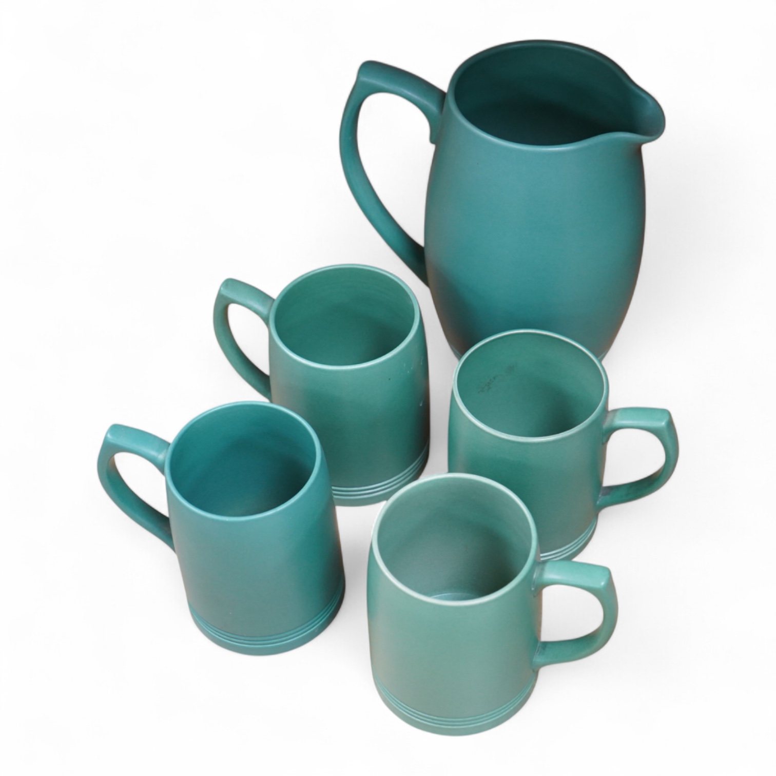 Keith Murray for Wedgwood green glazed lemonade jug and four green mugs, largest 21cm high
